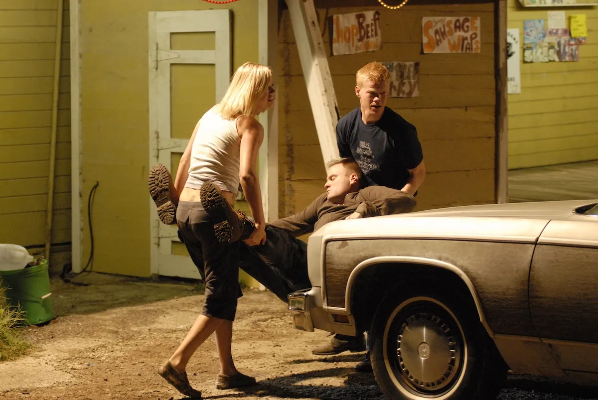 Tyra (Adrianne Palicki) and Landry (Jesse Plemons) carrying a body in 'Friday Night Lights' Season 2