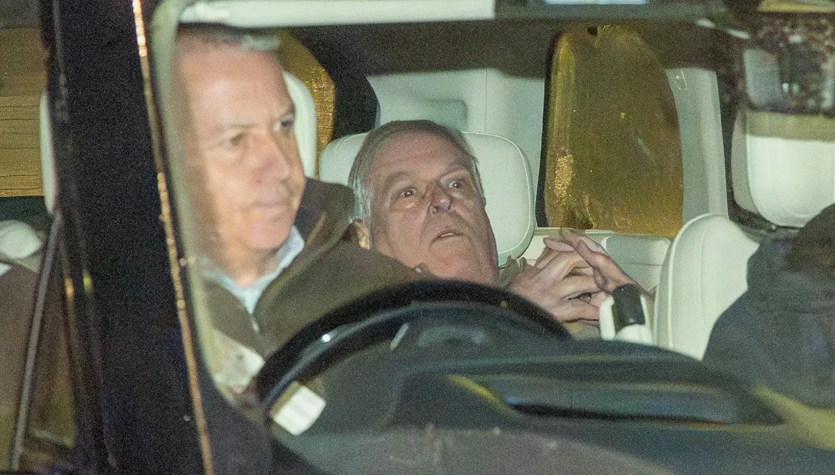 Andrew Mountbatten-Windsor is seen being driven away from a police station following his arrest on suspicion of misconduct in a public office