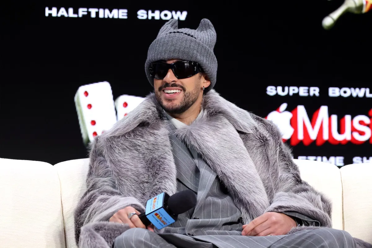 Bad Bunny wearing a hat and sunglasses at the Super Bowl Halftime Show press conference