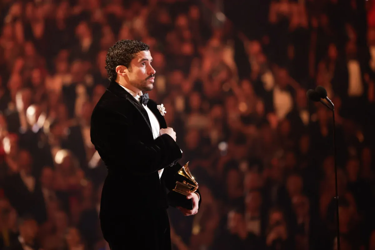Bad Bunny wears a suit and stands on the stage at the Grammys.