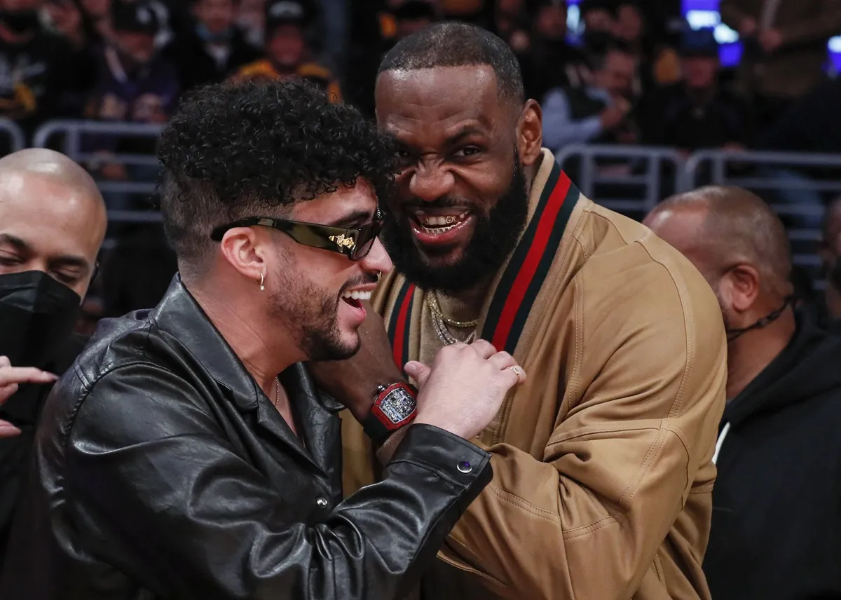 Bad Bunny and LeBron James share a laugh during a break in the action at an NBA game