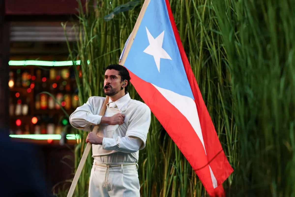 Bad Bunny holds the Puerto Rican flag during his Super Bowl halftime show.