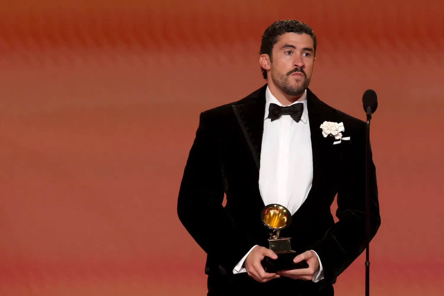 Bad Bunny in a tuxedo accepting an awards at the 68th annual Grammy Awards