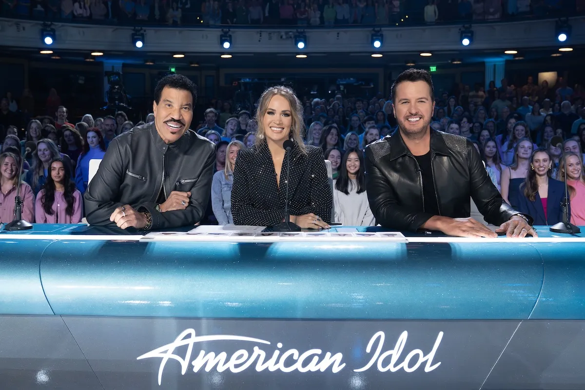 Lionel Richie, Carrie Underwood, and Luke Bryan posing at the judges table on 'American Idol' Season 24
