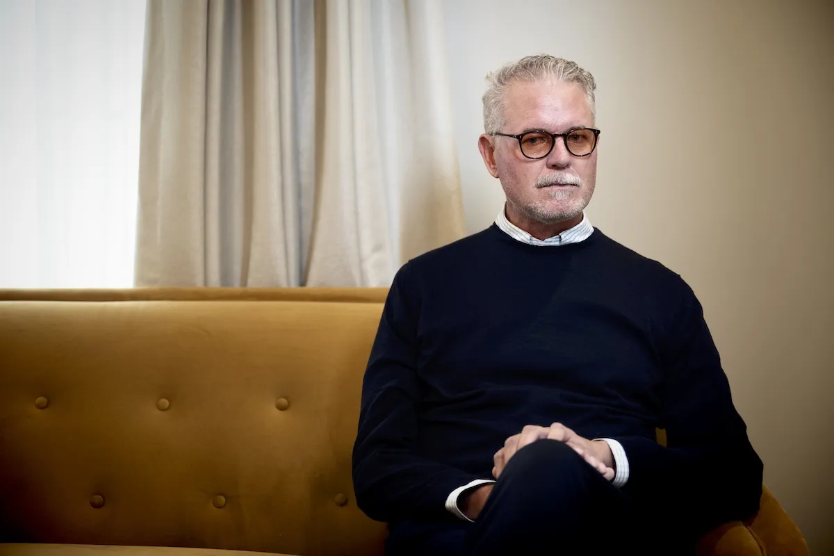 Eric Dane sitting on a couch