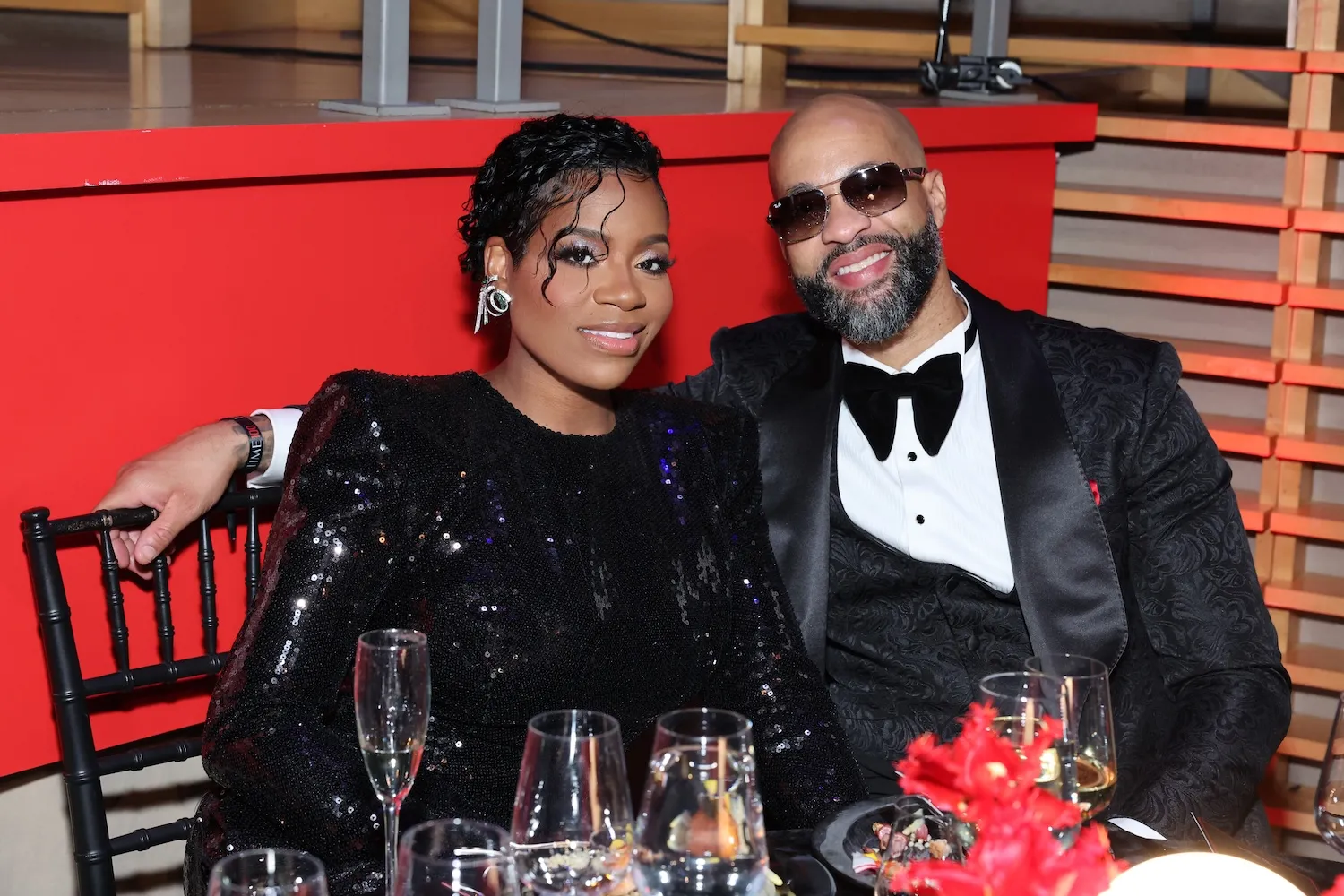 Fantasia Barrino and Kendall Taylor dressed up and sitting together at a table at an event in 2024