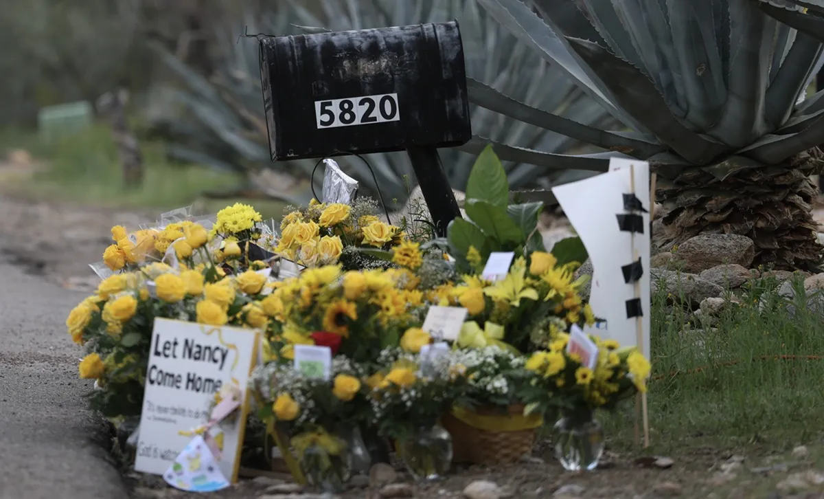 A memorial set up near the driveway of Nancy Guthrie's residence on February 20, 2026, in Tucson, Arizona