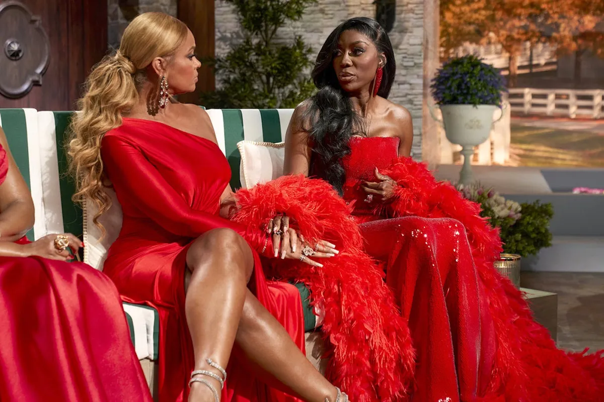 Gizelle Bryant and Wendy Osefo, both in red dresses, on stage at 'The Real Housewives of Potomac' Season 10 reunion