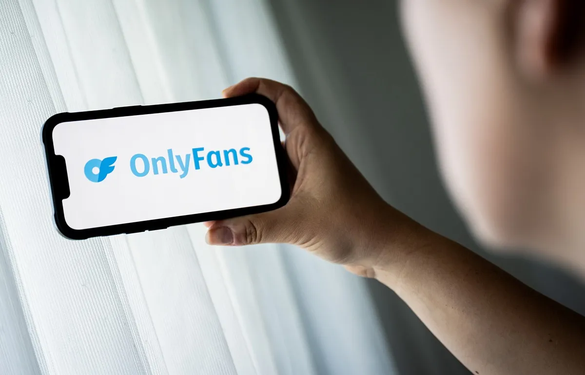 In this photo illustration, a OnlyFans logo is seen displayed on a smartphone