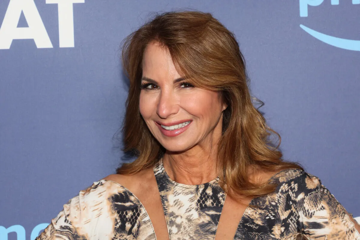 Jill Zarin wears a snake patterned shirt and smiles.