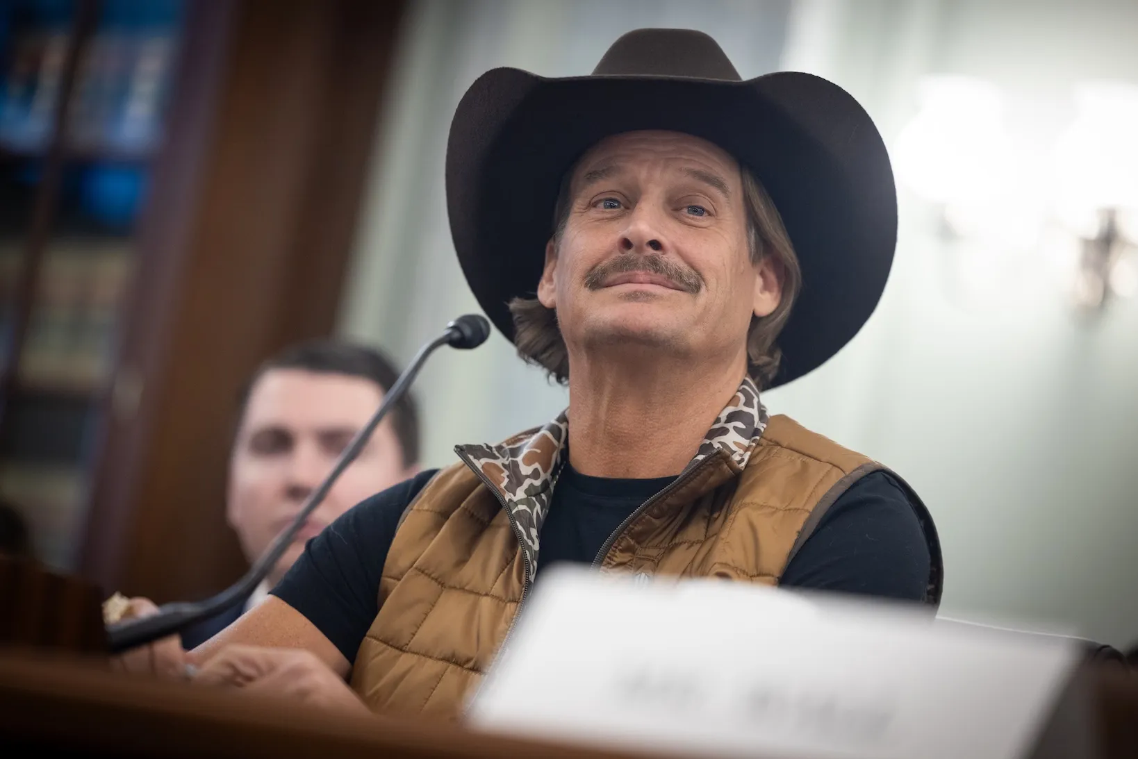 Kid Rock smiling and wearing a cowboy hat at a Senate hearing in 2026