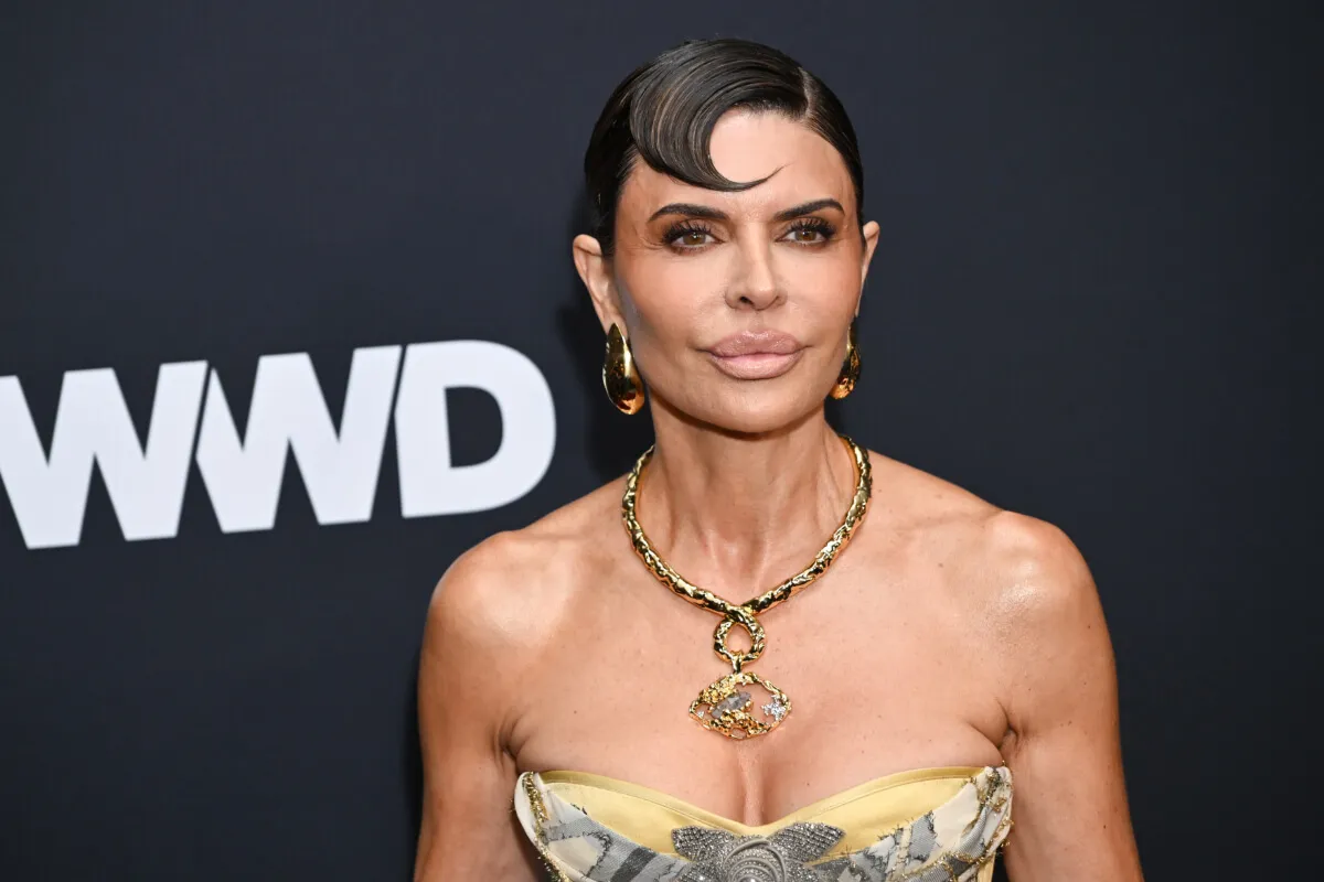 Lisa Rinna wears a strapless dress and a gold necklace and earrings.