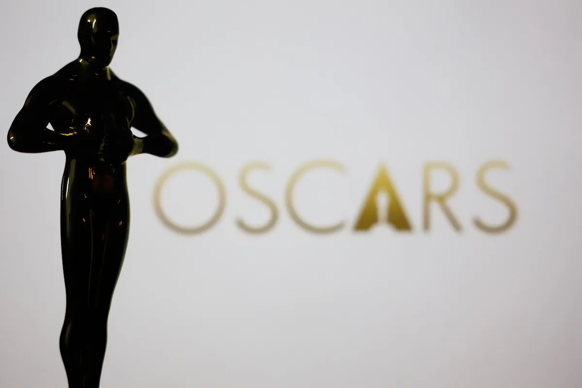 Silhouette of an Oscars statuette against a white background reading "Oscars"