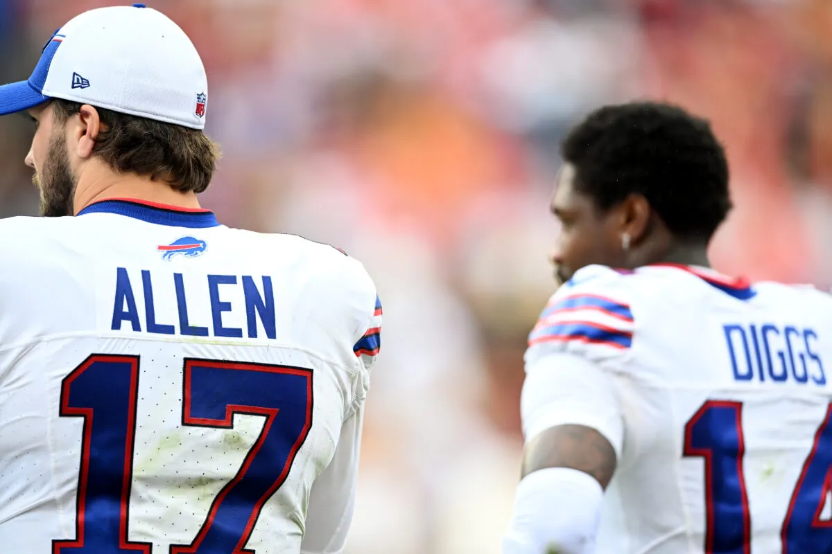 Josh Allen and Stefon Diggs wear their Buffalo Bills uniforms and stand with their backs to the camera.