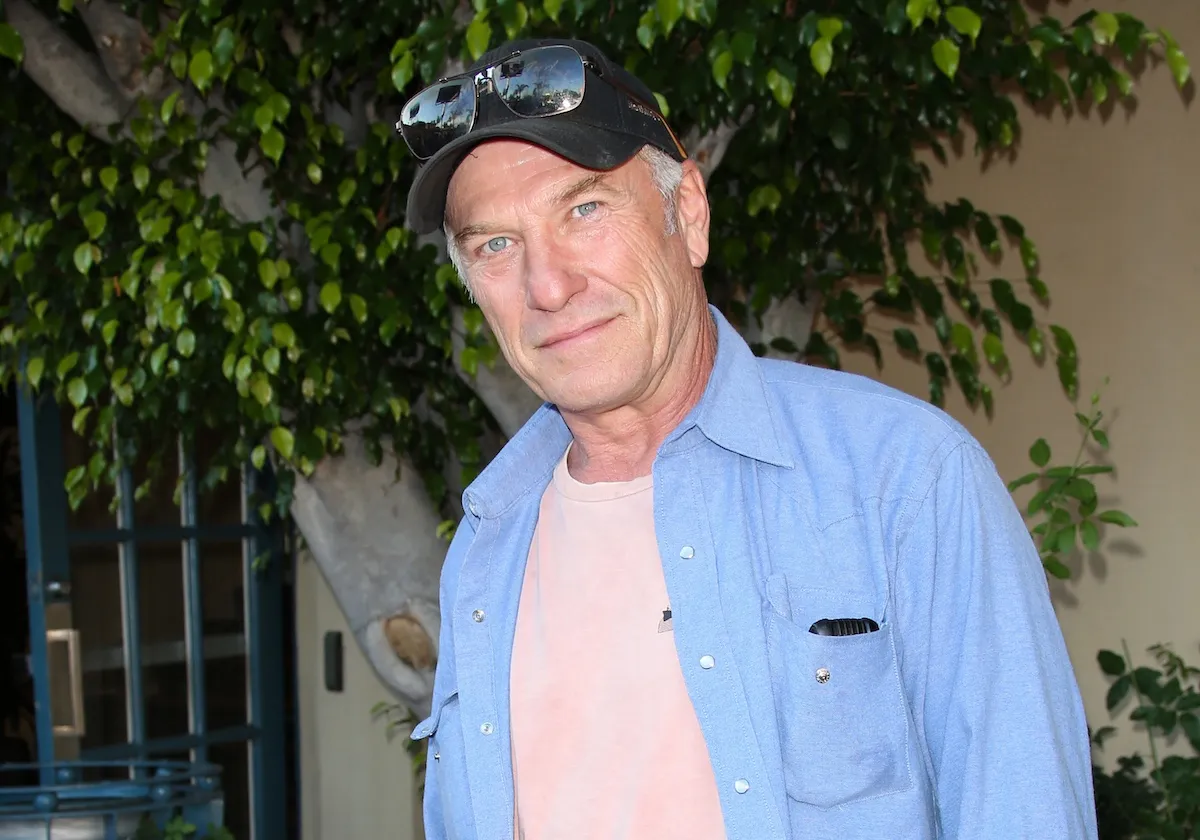 Actor Ted Levine from 'The Silence of the Lambs' wearing a baseball hat with sunglasses on the brim