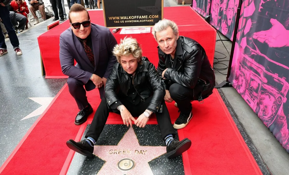 Tré Cool, Billie Joe Armstrong and Mike Dirnt of Green Day pose with their star during their Hollywood Walk of Fame Star Ceremony