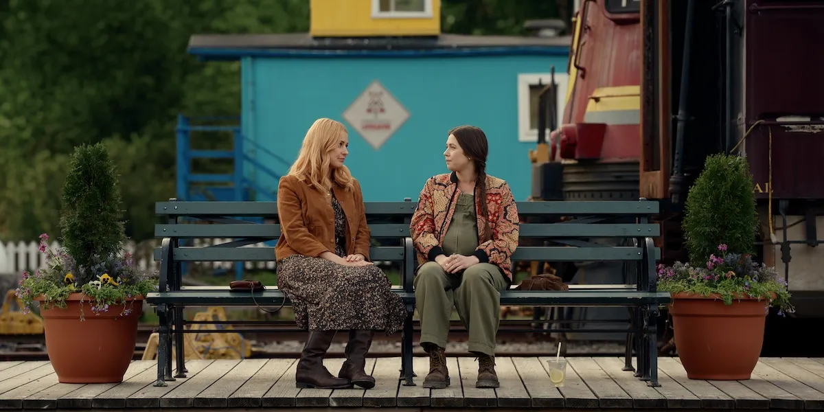 Mel and another woman sitting on a bench in 'Virgin River' Season 7
