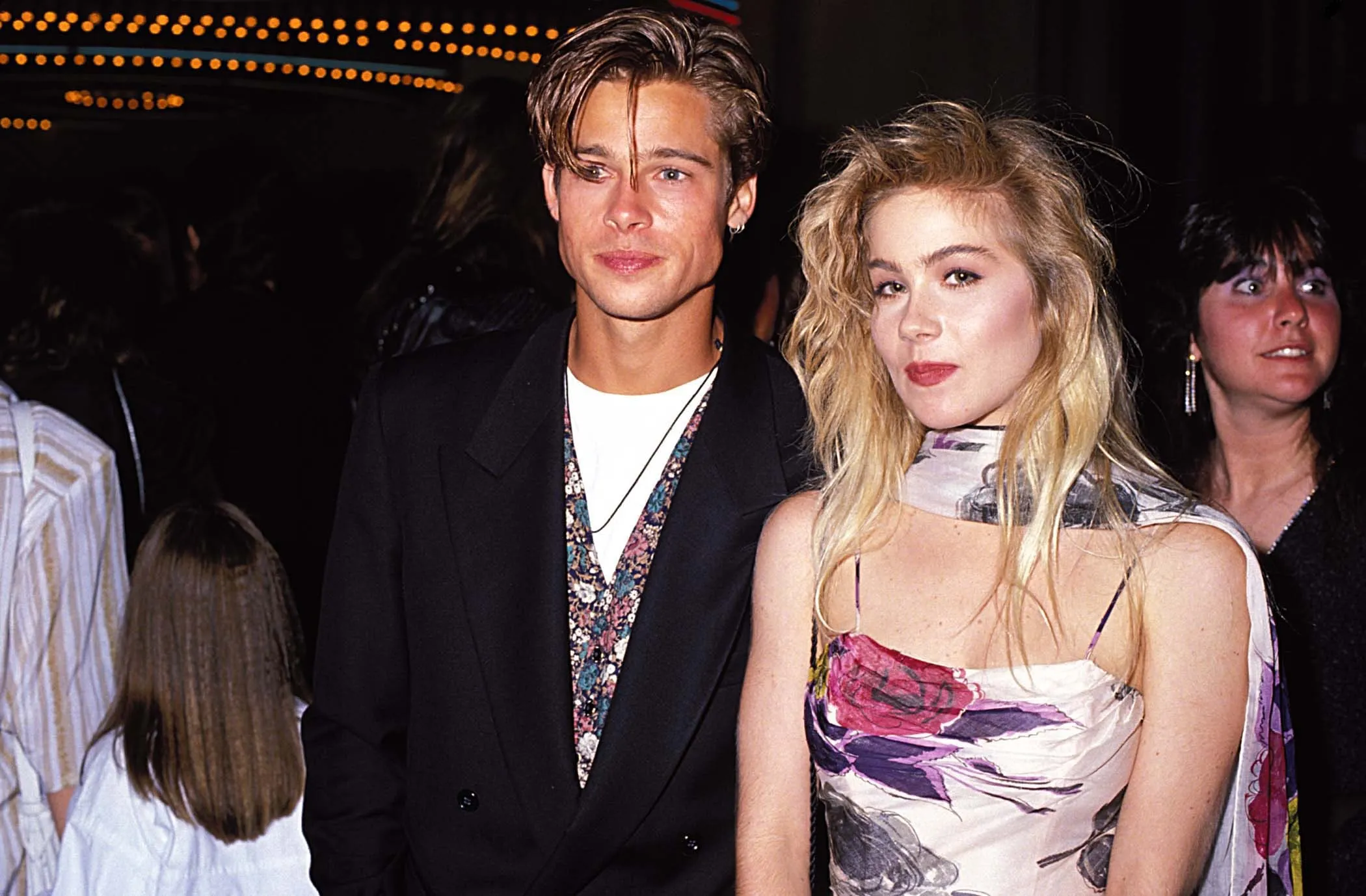 Brad Pitt and Christina Applegate standing next to each other and slightly smiling at the 1989 MTV Video Music Awards