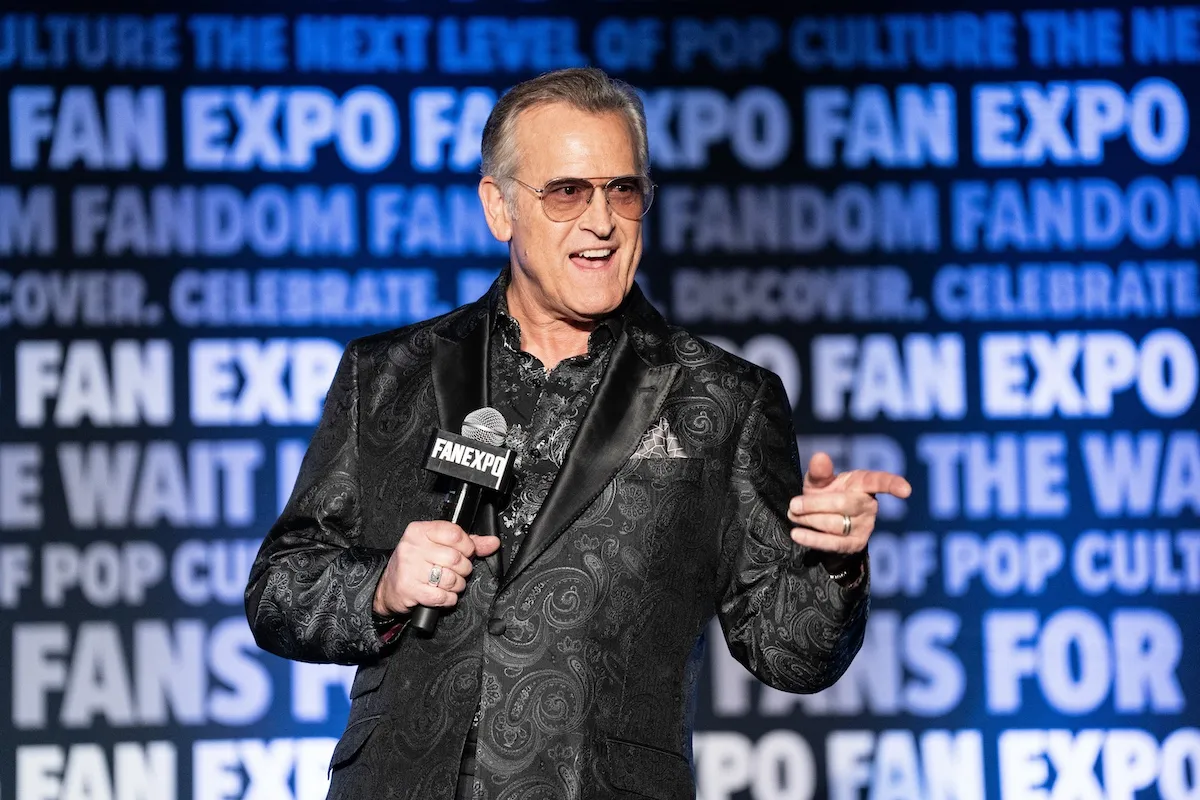 Actor Bruce Campbell wearing a black jacket and sunglasses