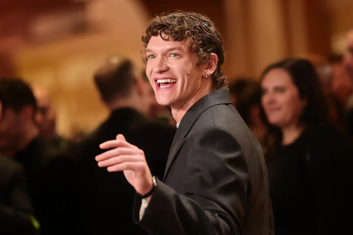 Connor Storrie of 'Heated Rivalry' looking over his shoulder and pointing