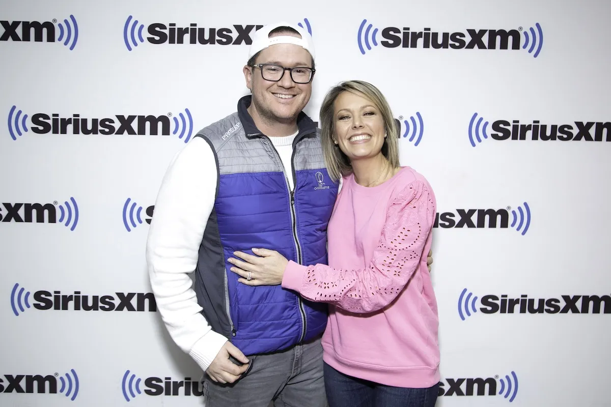 Dylan Dreyer and Brian Fichera hugging and smiling against a SiriusXM background