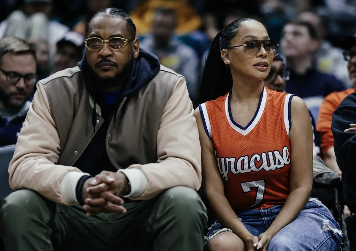 Former basketball player Carmelo Anthony and La La Anthony look on during the game between the Houston Cougars and the Syracuse Orange