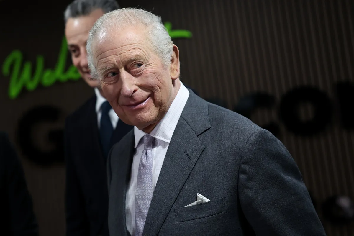 King Charles III smiles as he departs following a visit to a Greencore food manufacturing site