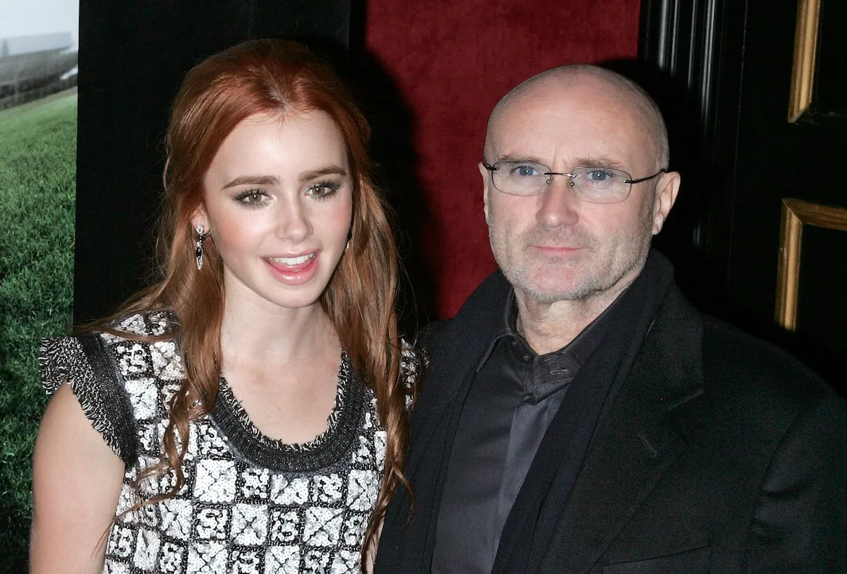 Lily Collins and father Phil Collins posing together in 2009