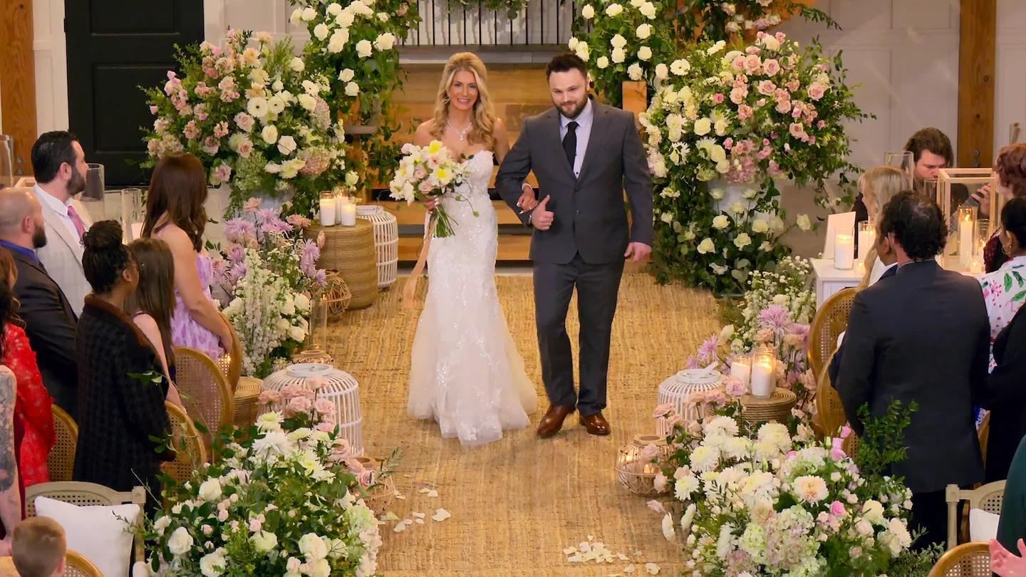 'Love Is Blind' Season 10 couple Amber and Jordan walking down the aisle together on their wedding day.