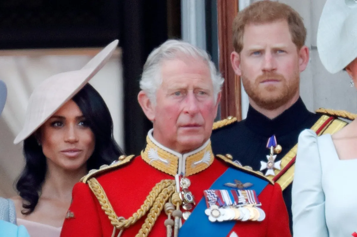 Meghan Markle, King Charles, and Prince Harry standing on the balcony of Buckingham Palace during Trooping The Colour 2018