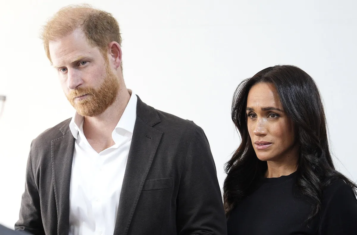 Prince Harry and Meghan Markle looking concerned