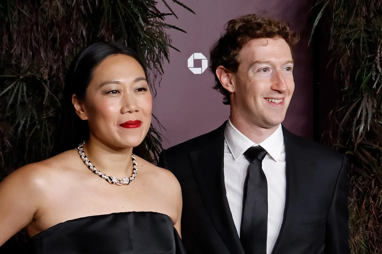 A close-up of Priscilla Chan and Mark Zuckerberg at an event. They are dressed up in a suit and a dress.