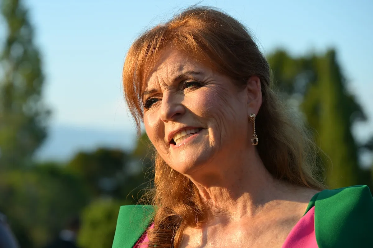 Sarah Ferguson standing outside in a green dress