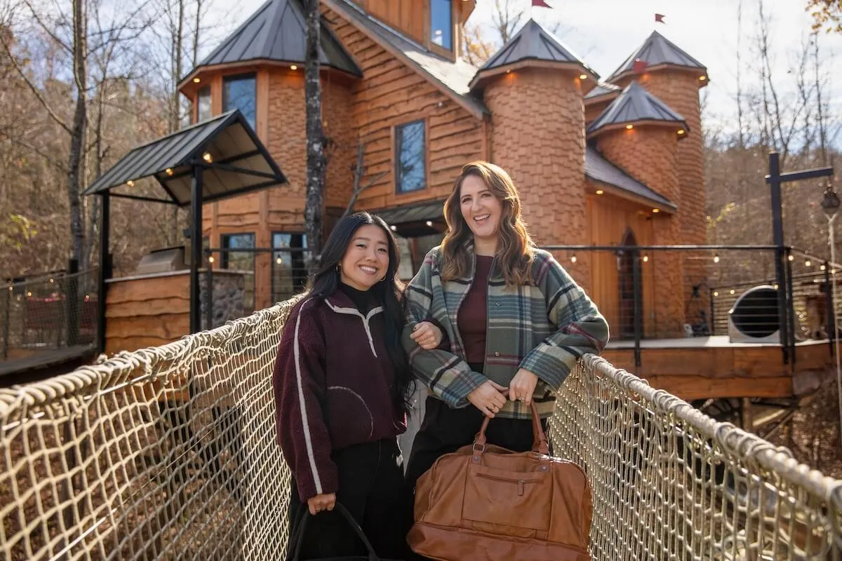 Sherry Cola and D'Arcy Carden standing in front of a house in HGTV's 'Wild Vacation Rentals'
