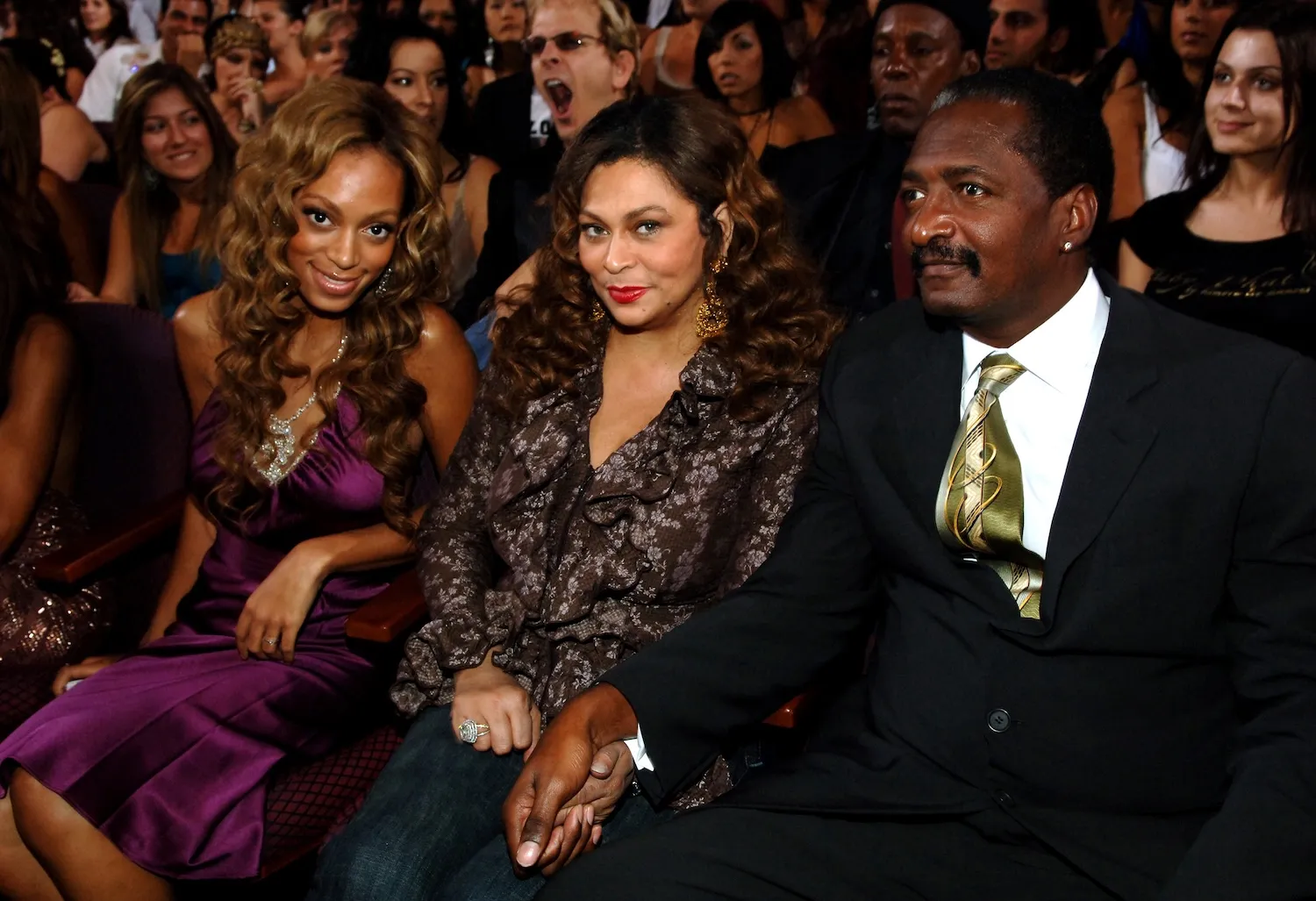 Solange Knowles, Tina Knowles, and Mathew Knowles sitting next to each other at an awards show in 2005.