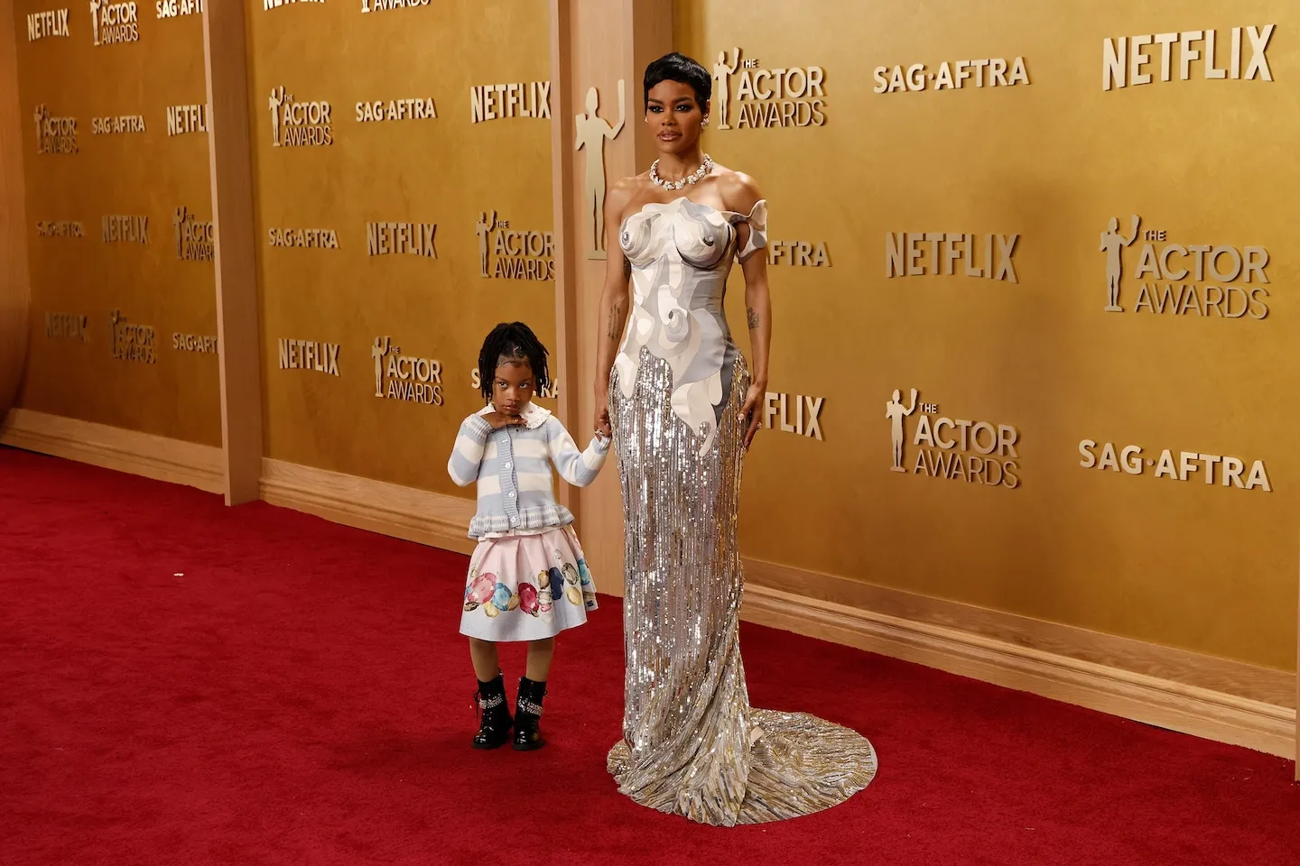 Rue Rose Shumpert and Teyana Taylor holding hands on the red carpet at the Actor Awards in 2026.
