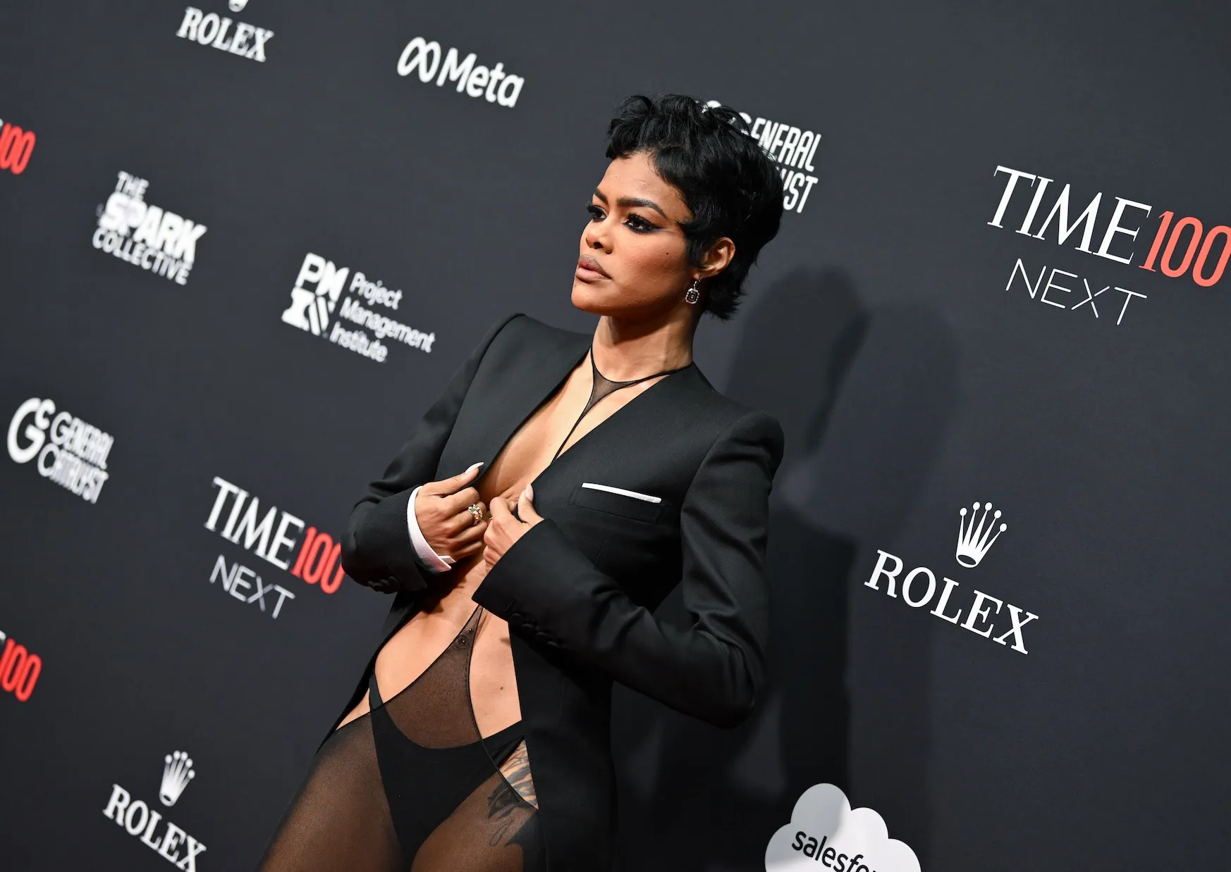 A side view of Teyana Taylor at the 2025 TIME100 Next event. She's wearing a black lingerie-inspired look beneath a black blazer