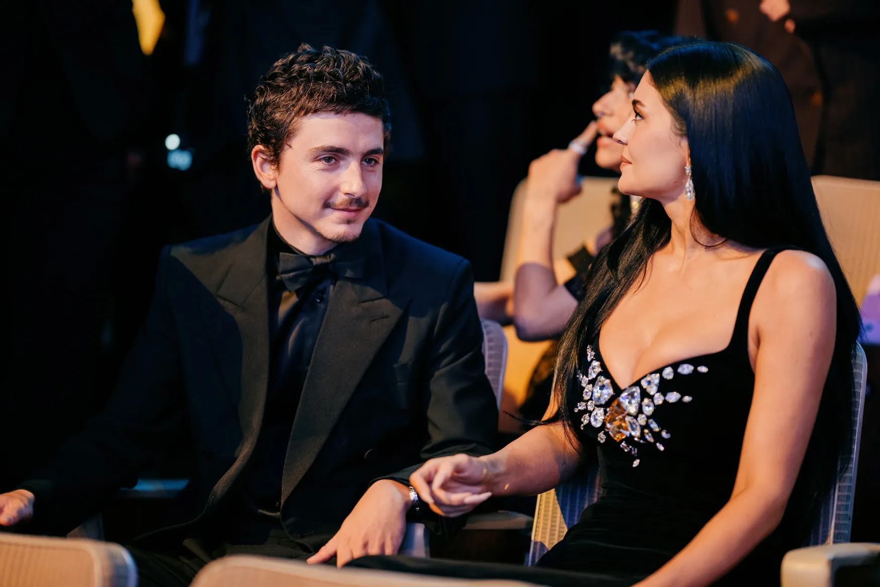 Timothée Chalamet and Kylie Jenner looking in opposite directions while seated next to each other at the BAFTA Film Awards in 2026