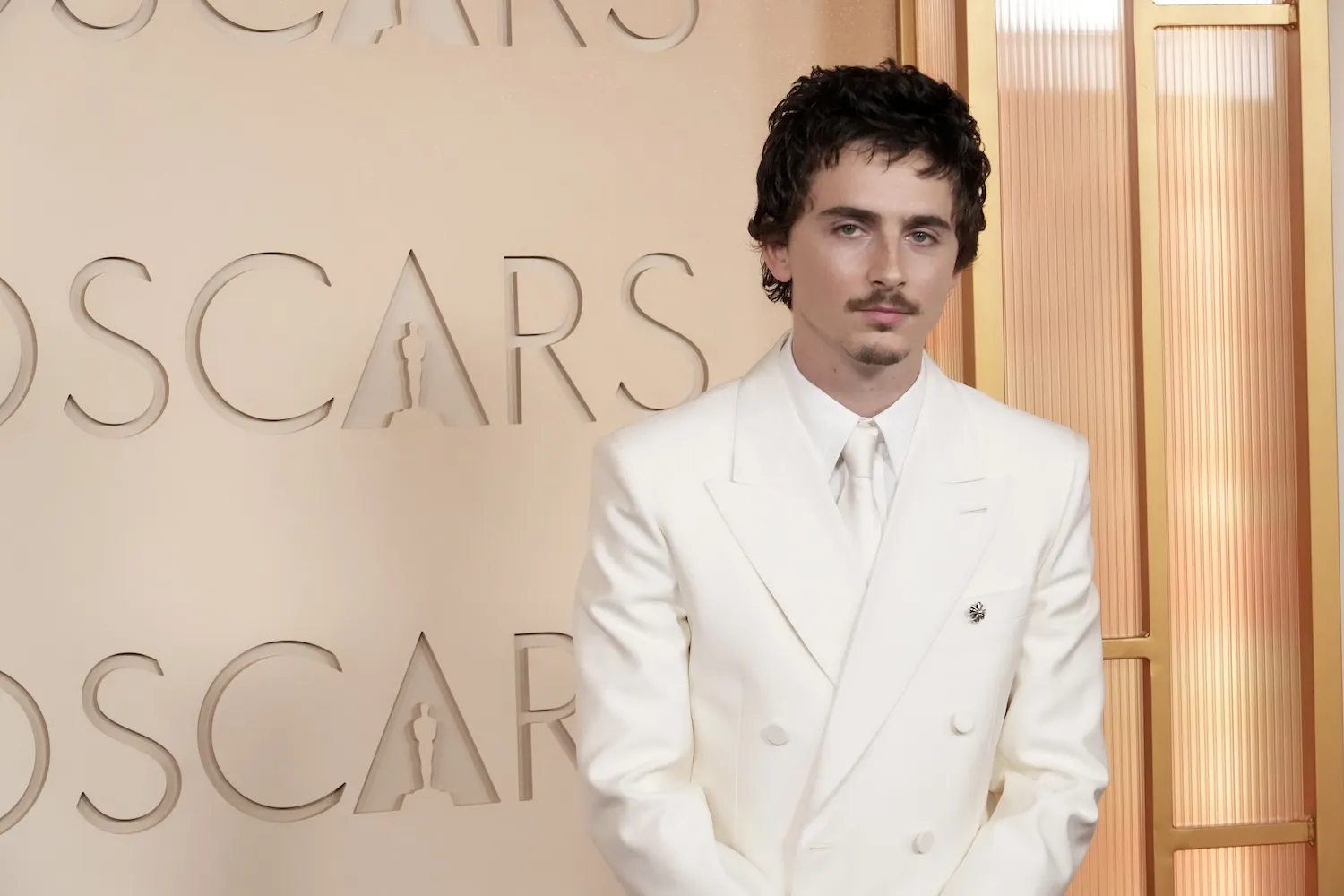 Timothée Chalamet in a white suit at the Oscars in 2026.