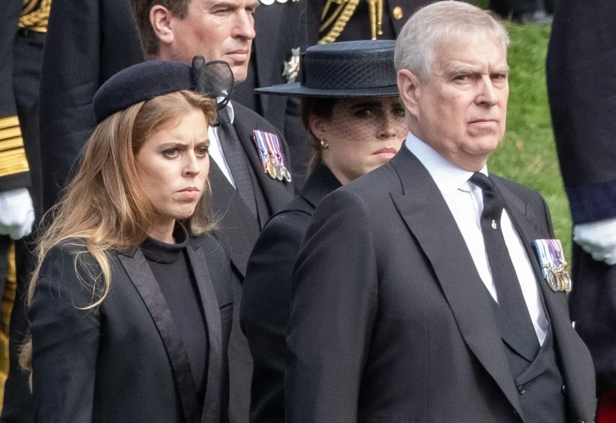 Andrew Mountbatten-Windsor and Princess Beatrice watch as the coffin of Queen Elizabeth II is carried by gun carriage to Wellington Arch from Westminster Abbey