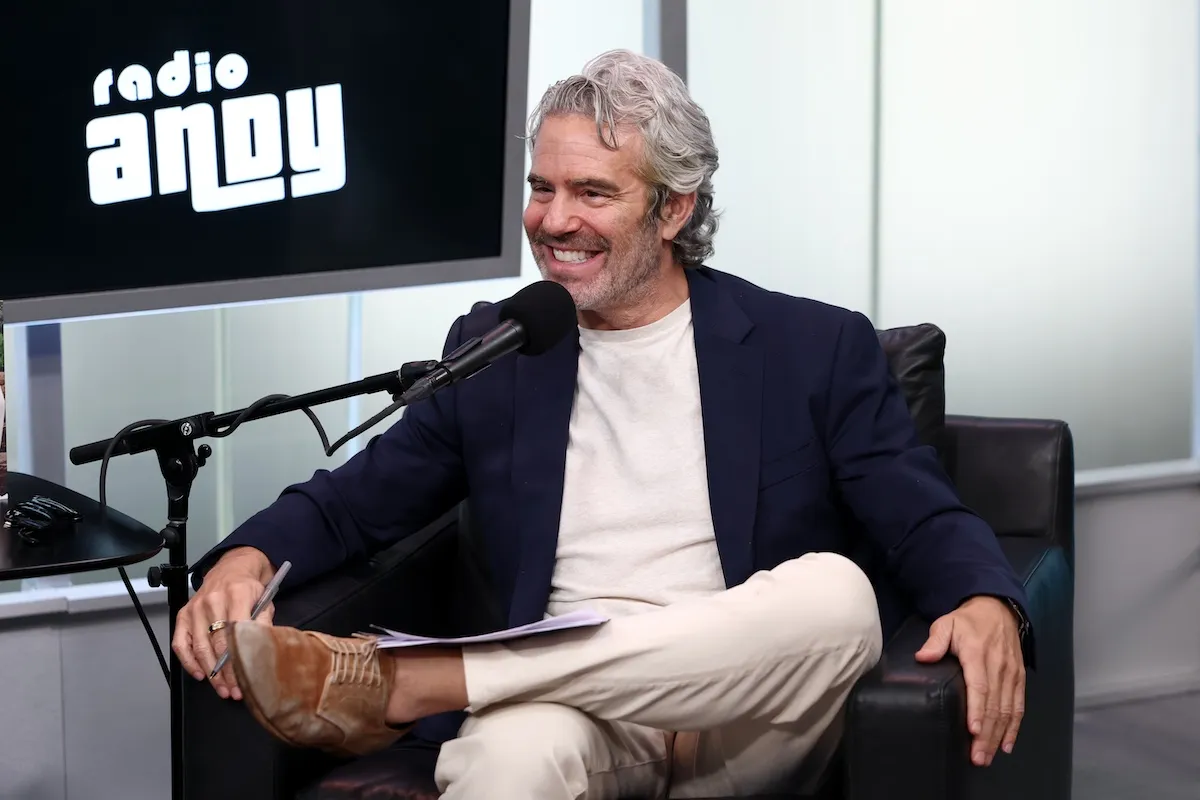 Andy Cohen speaking into a microphone on an episode of 'Radio Andy'