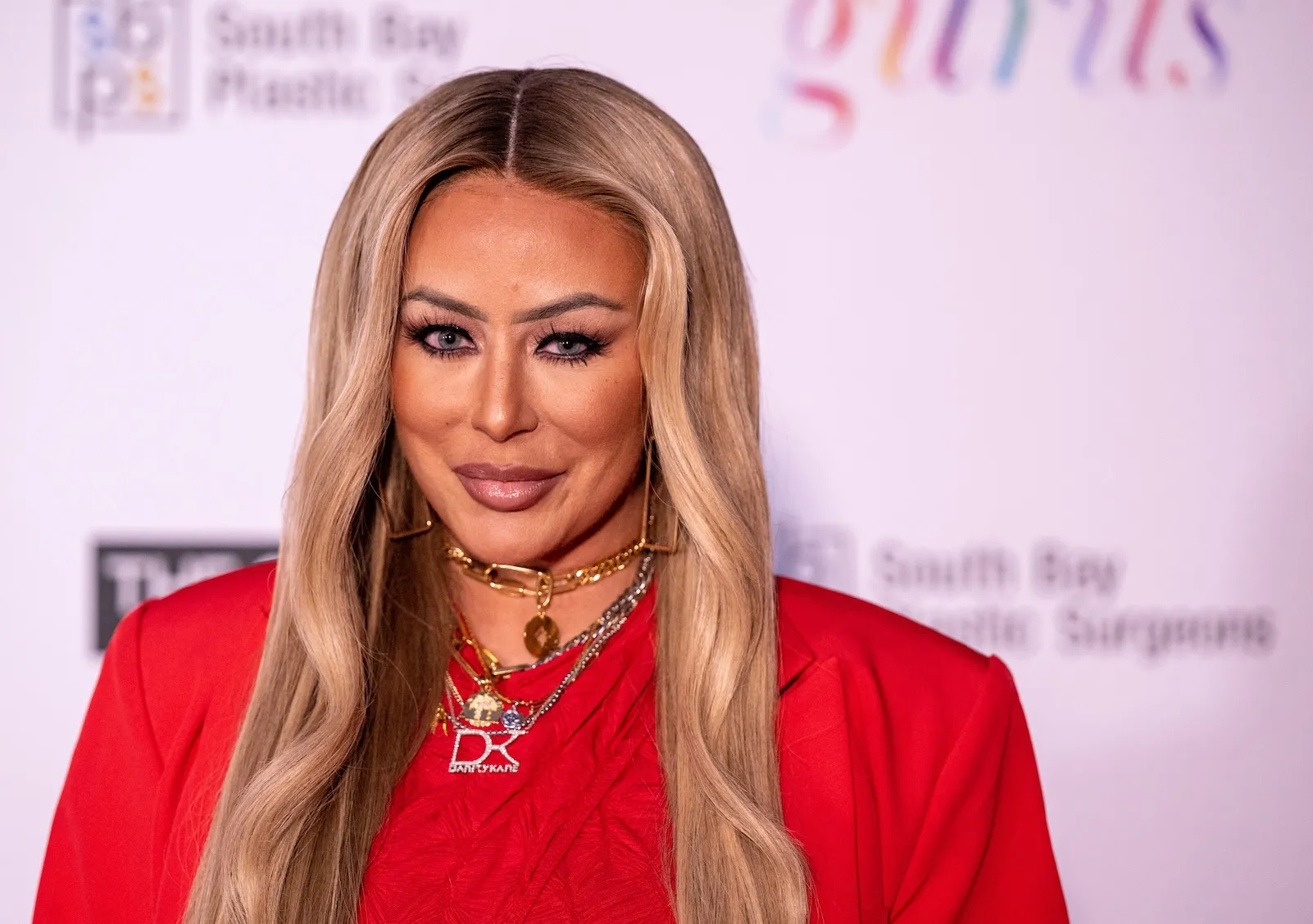 Aubrey O'Day posing in a red outfit in June 2024