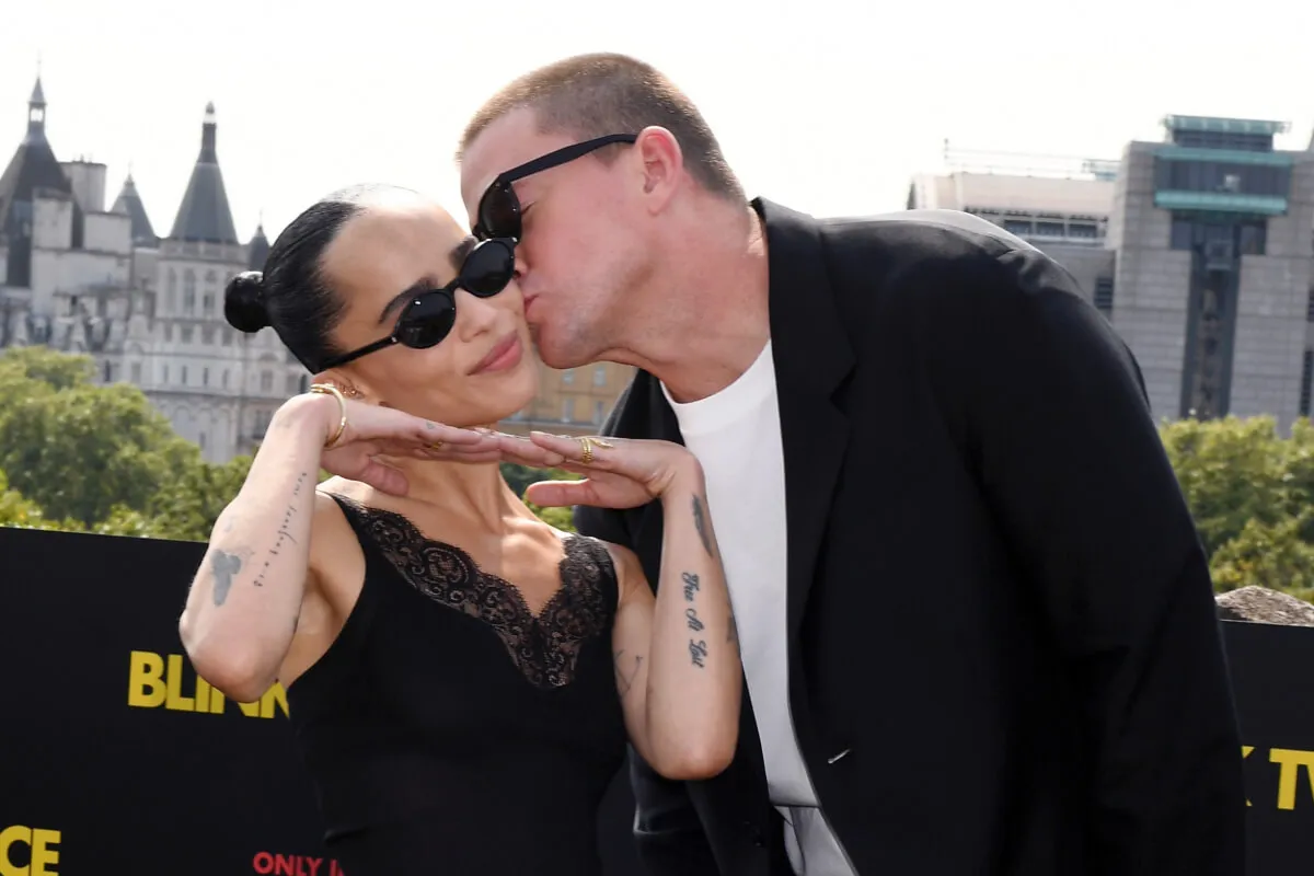 Zoe Kravitz wears black with sunglasses. Channing Tatum kisses her on the cheek. He wears sunglasses.