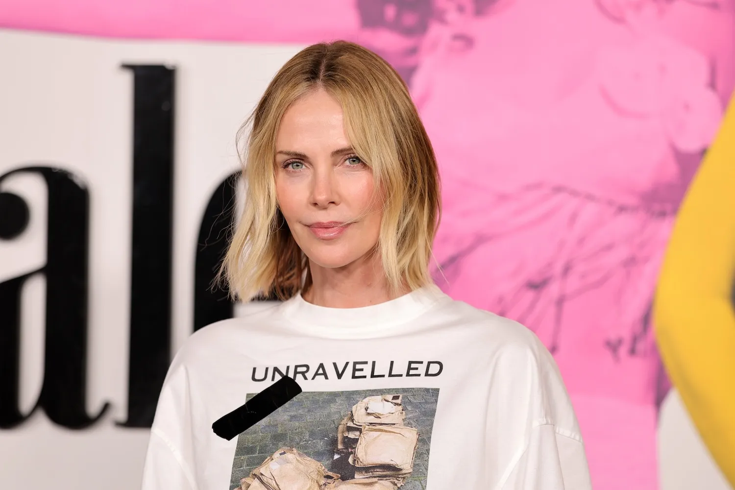 Charlize Theron in 2026 against a pink background