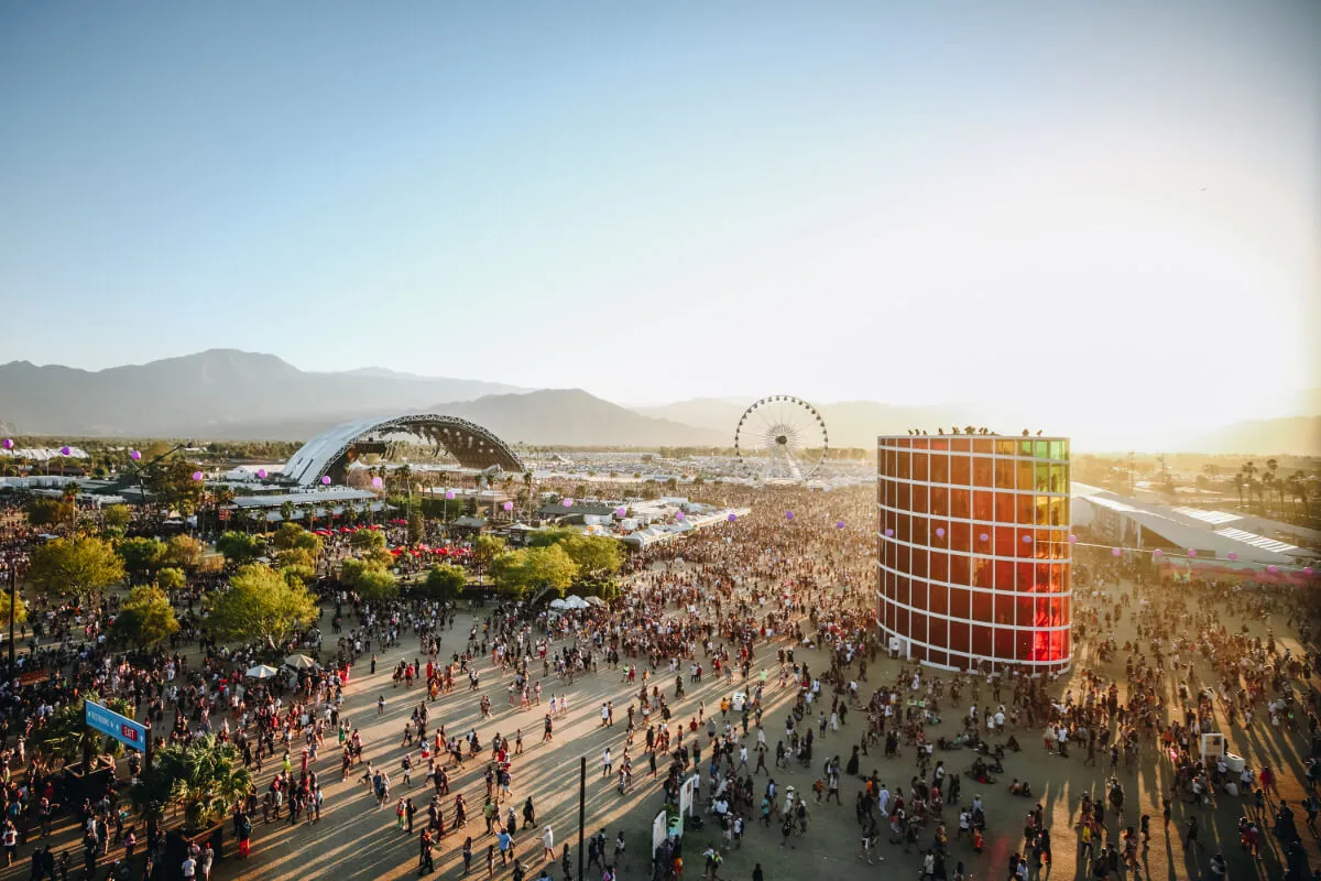 An aerial shot of Coachella. Crowds walk walk through the festival grounds.
