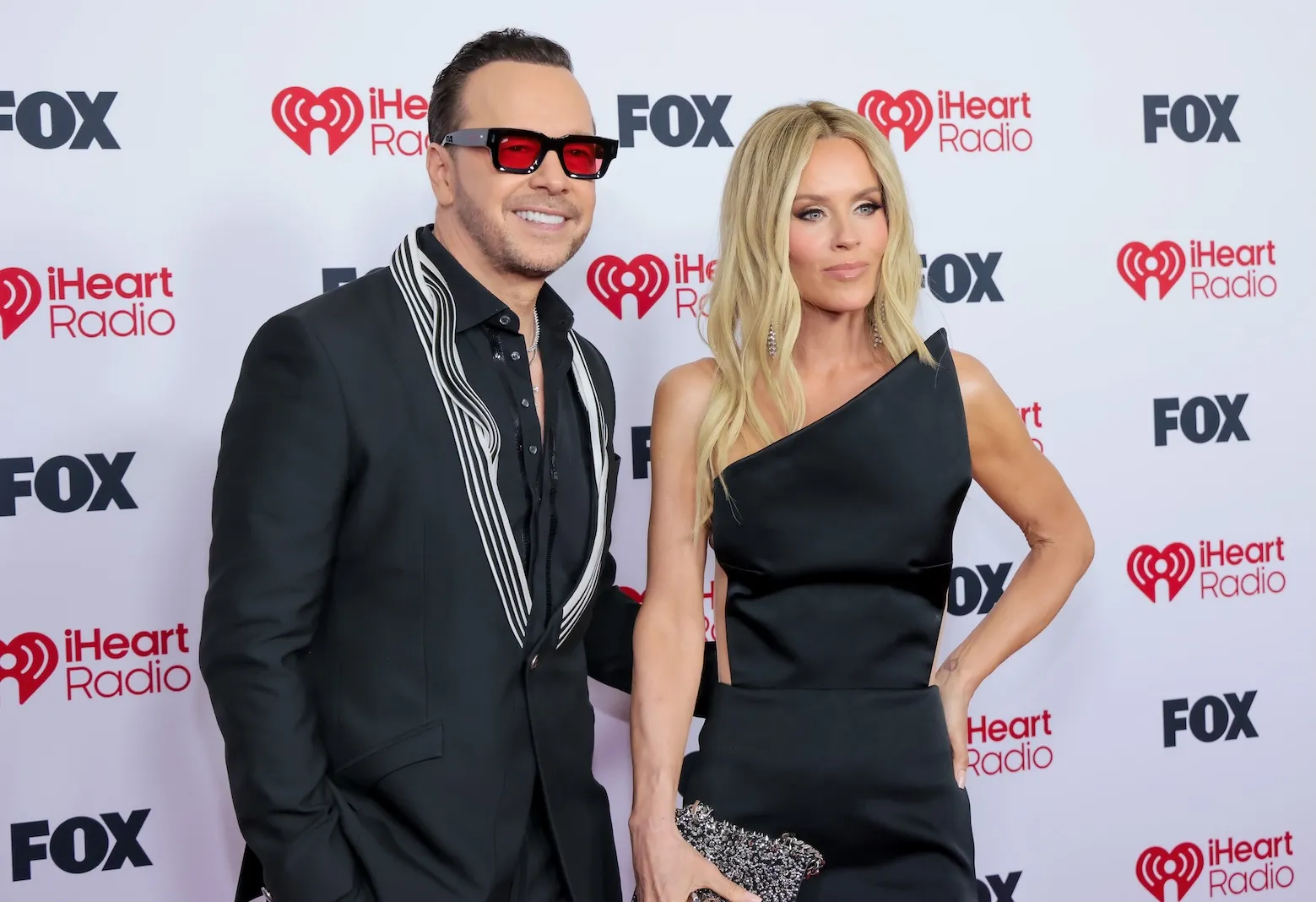 Donnie Wahlberg and Jenny McCarthy posing at the 2026 iHeartRadio Music Awards