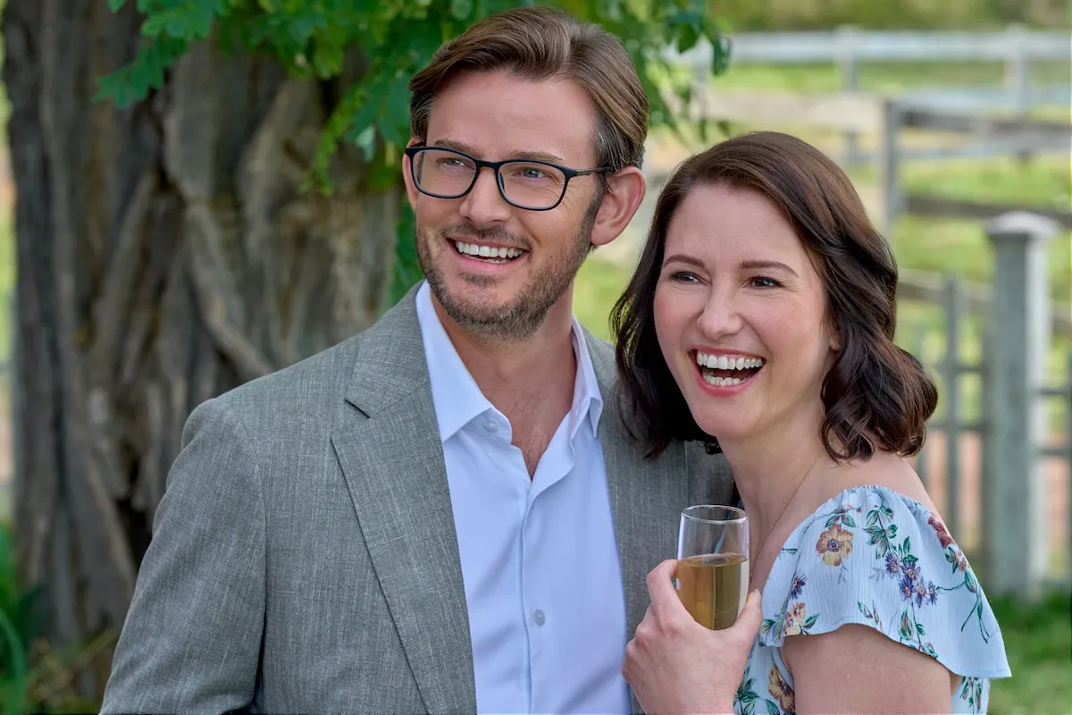 Smiling Eliot, with glasses, and Kat, in a floral dress, in 'The Way Home' Season 4 premiere