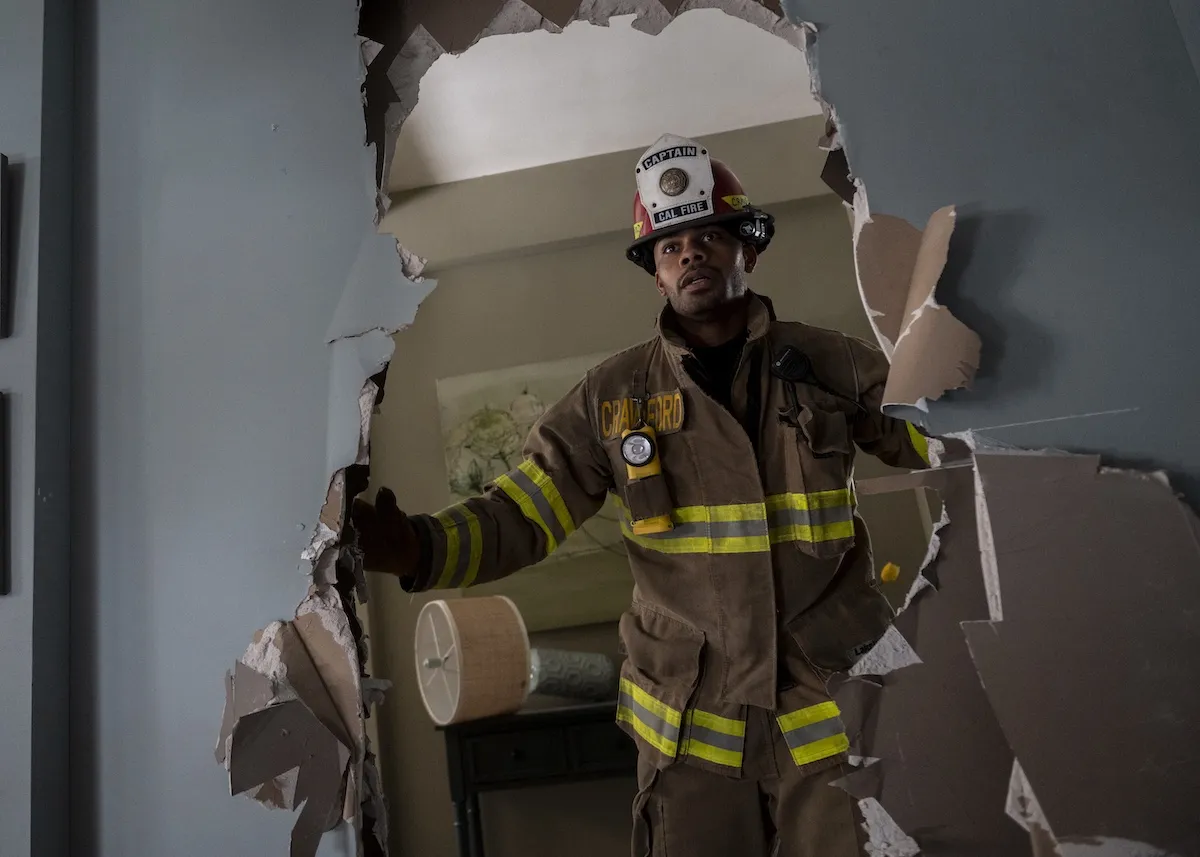 Firefighter looking through a broken wall in 'Fire Country' Season 4