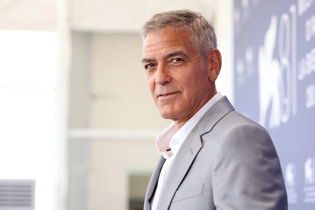 George Clooney wears a gray suit.