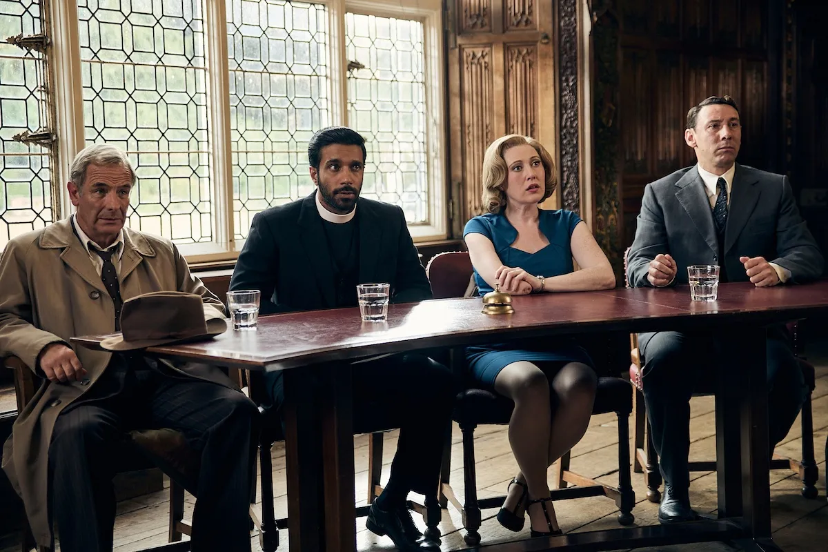 Geordie, Alphy, Miss Scott, and Larry sitting at at table in 'Grantchester' Season 11